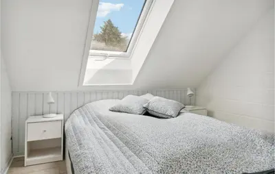 a white bedroom with a bed and a window at Awesome Apartment In Blokhus With Wifi in Blokhus