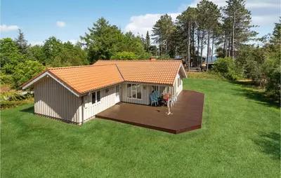 a small house with a deck in a yard at 3 Bedroom Awesome Home In Højslev in Højslev