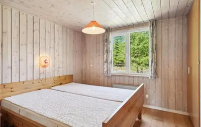 a bedroom with a bed and a window at 3 Bedroom Awesome Home In Højslev in Højslev