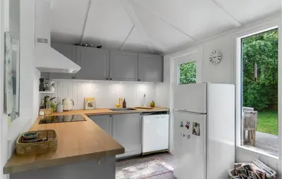 a kitchen with white cabinets and a white refrigerator at Awesome Home In Spøttrup With Wifi in Spottrup