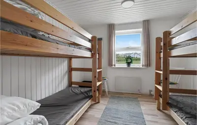 a bedroom with two bunk beds and a window at 2 Bedroom Cozy Home In Lemvig in Lemvig
