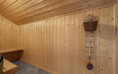 a wooden wall of a sauna with a bucket at Stunning Home In Vestervig With Sauna in Vestervig