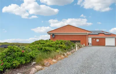a brick house with a driveway in front of it at 4 Bedroom Stunning Home In Thisted in Thisted