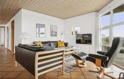 a living room with a couch and a desk at 4 Bedroom Stunning Home In Thisted in Thisted